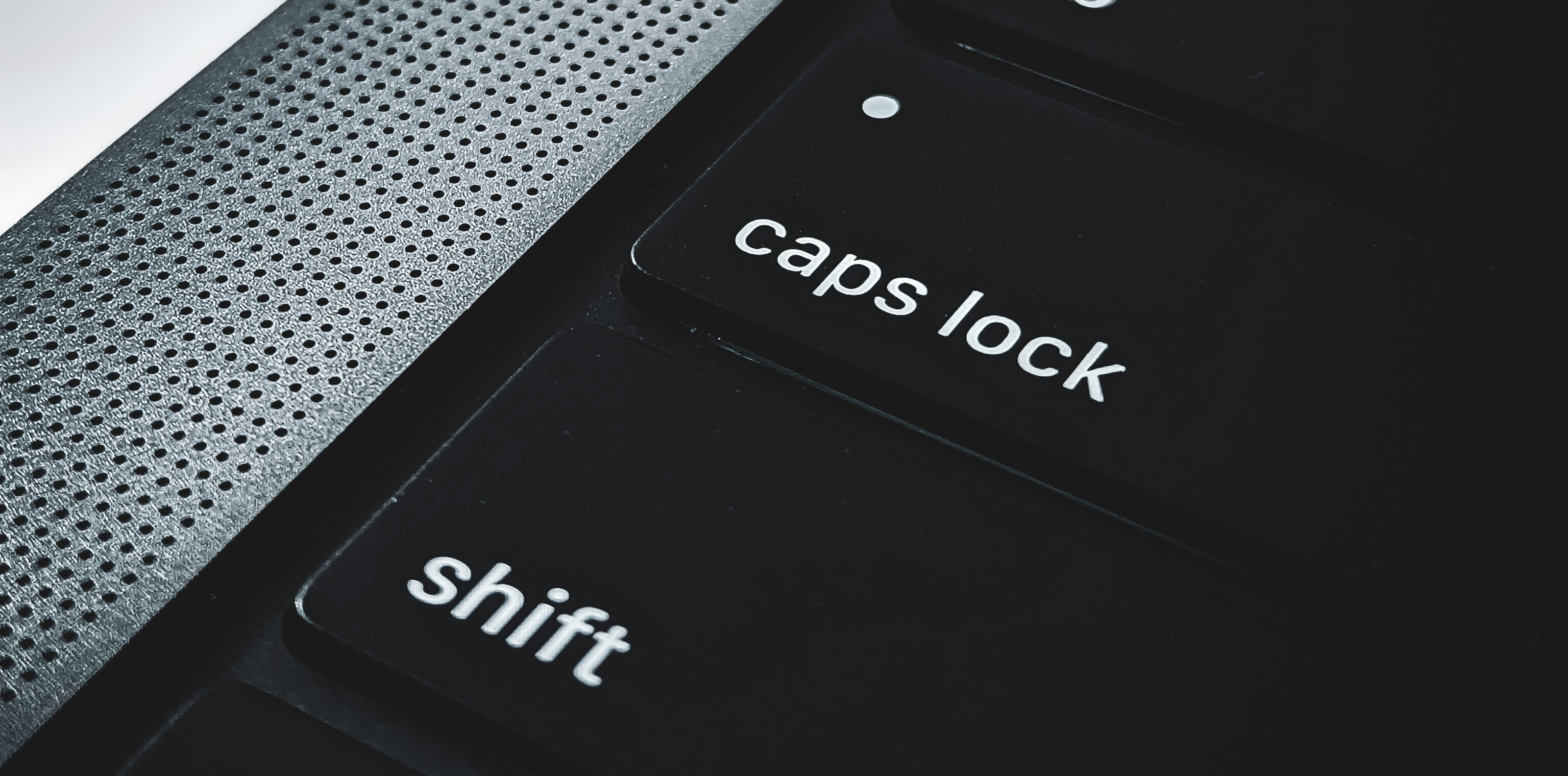 Apple MacBook keyboard close-up, shift and caps-lock