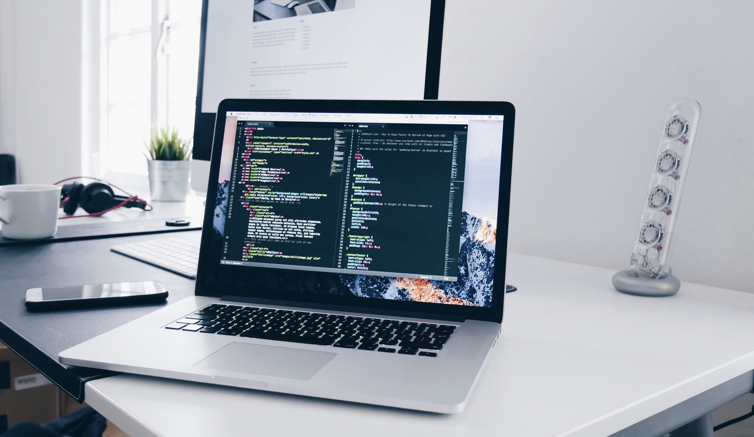 Apple MacBook with program source code displayed