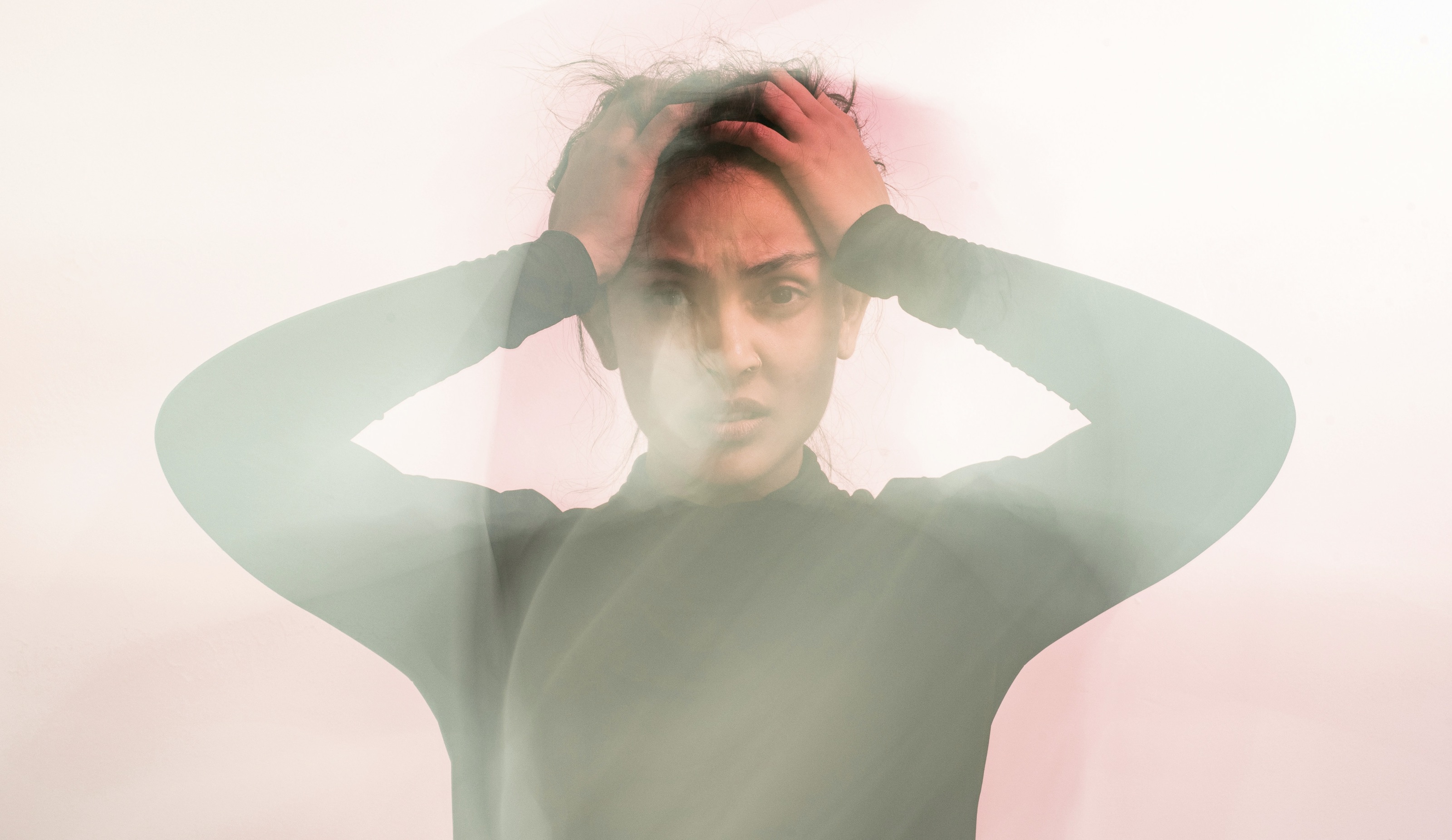 Woman holding head in confusion and frustration