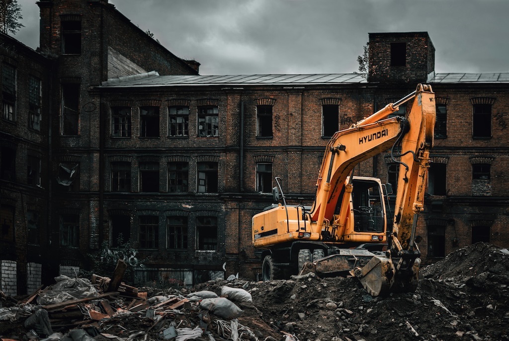 orange excavator on a demolition site