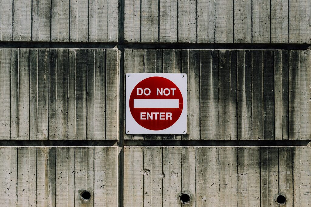 A white-and-red ‘Do Not Enter’ sign.