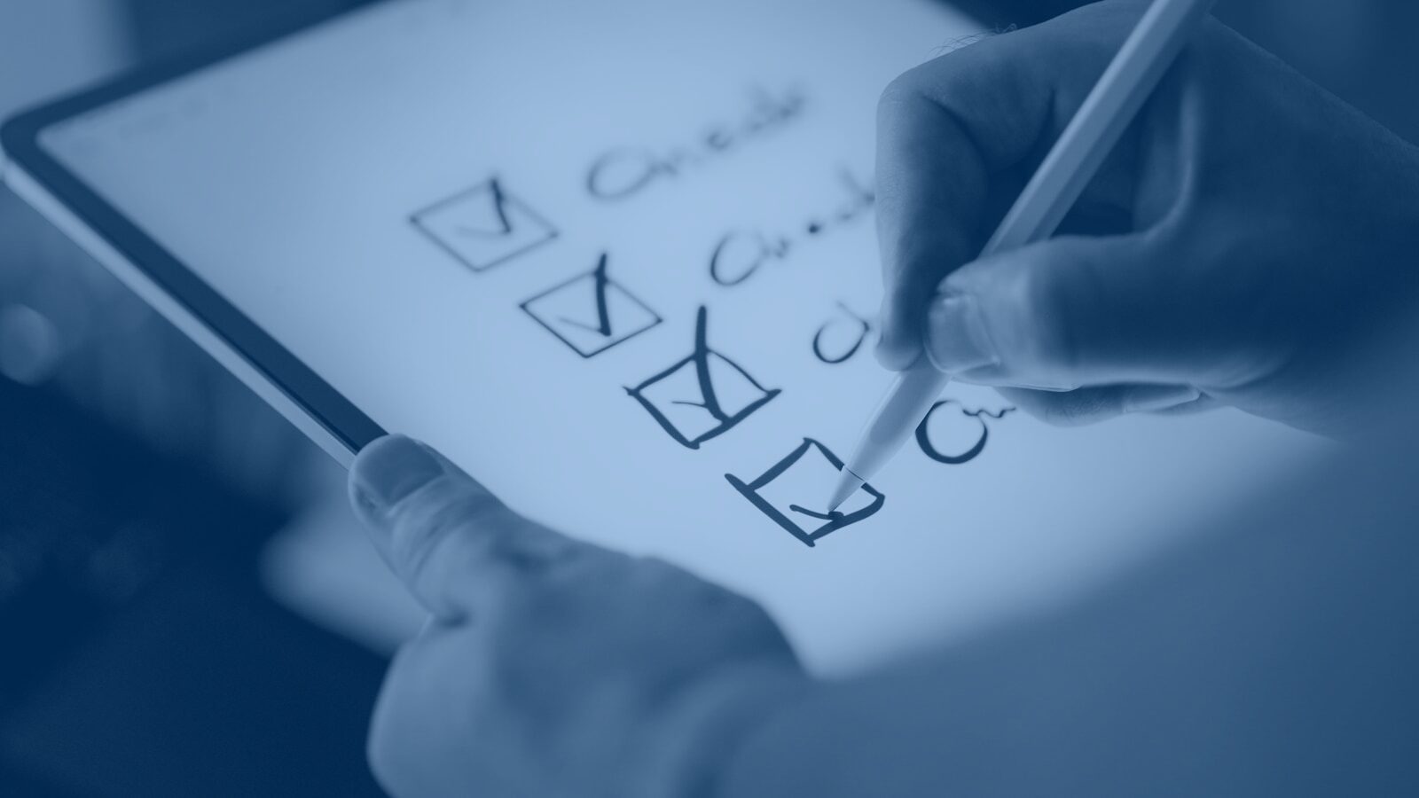 A hand ticking items off a checklist.