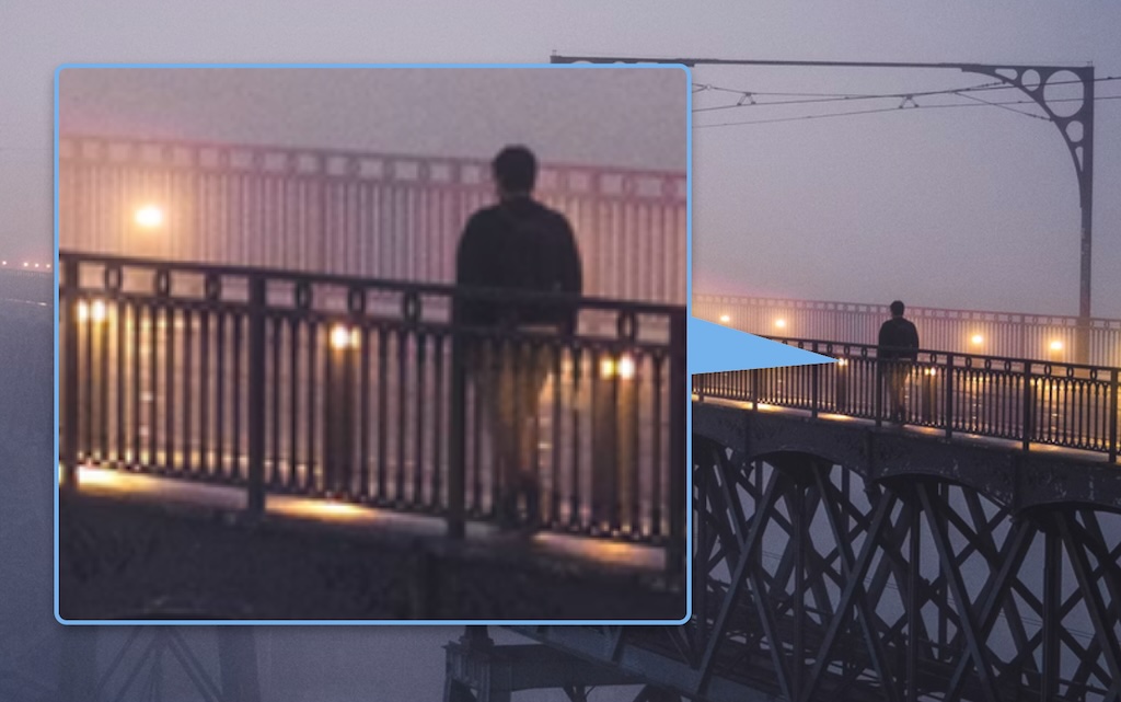 A HawkEye magnifier callout in action: one story's thumbnail on a news page magnified into a rounded callout, joined to its source by a tapered pointer, the callout outlined in an auto-chosen blue that contrasts with the dark image behind it.
